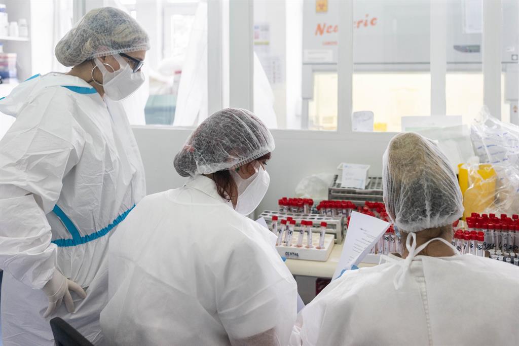 Health workers test saliva samples