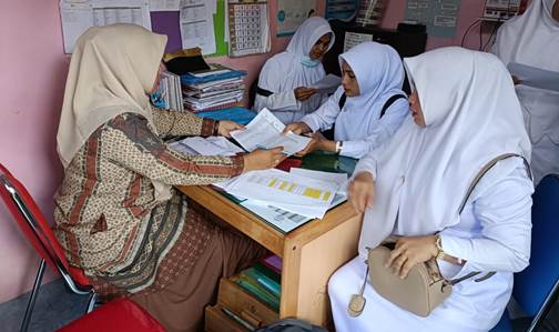 An immunization officer and midwifes in Pidie, Aceh